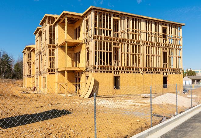 a close-up of temporary chain link fences enclosing a job site, signaling progress in the project's development in Atherton